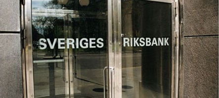 Riksbank halves interest rates