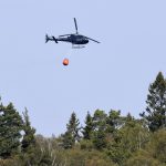 Helicopters water bomb wildfire outside Stockholm