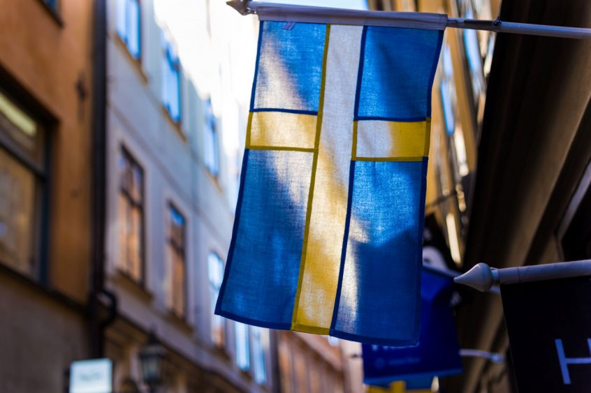 Swedish flag flying in Gamla Stan, Stockholm - Photo: Jonathan Brinkhorst/Unsplash