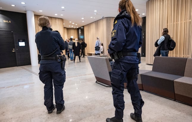 Police at Lund District Court in southern Sweden on the first day of the trial.