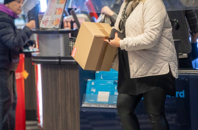 a woman collecting a parcel from an ICA supermarket