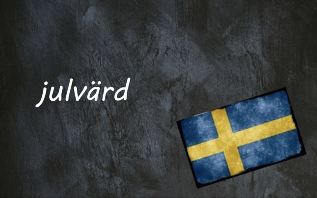 the word julvärd on a black background by a Swedish flag