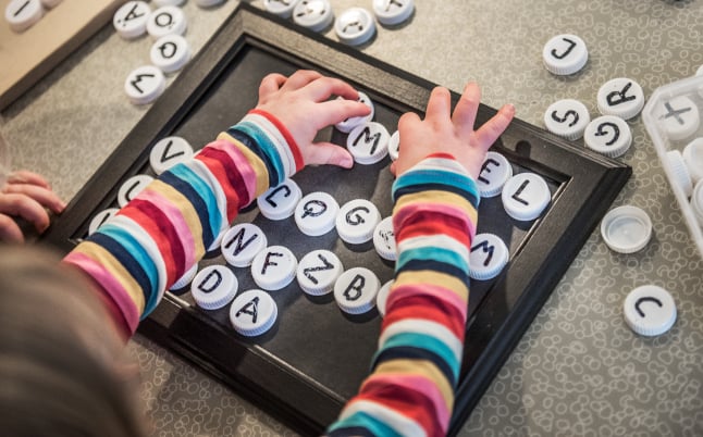 a child playing with letters of the alphabet