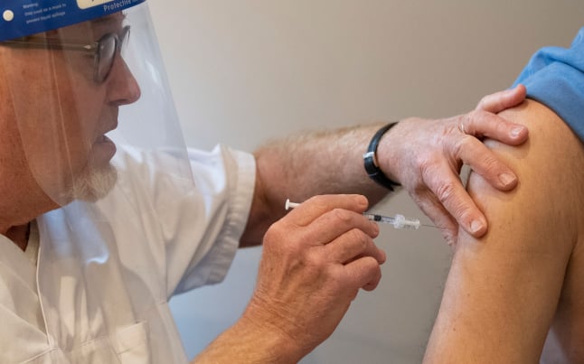 a nurse vaccinating a man